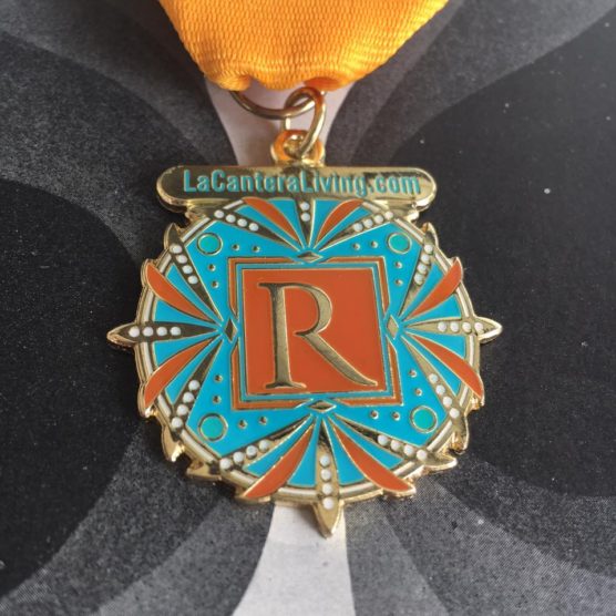 A medal with the letter r on it.