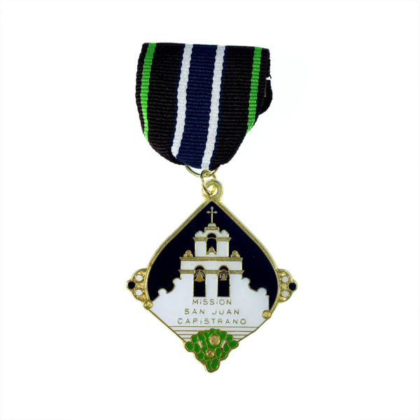 A medal with a picture of a church on it.