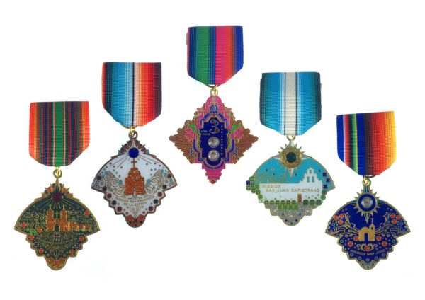 A group of medals hanging from ribbons.