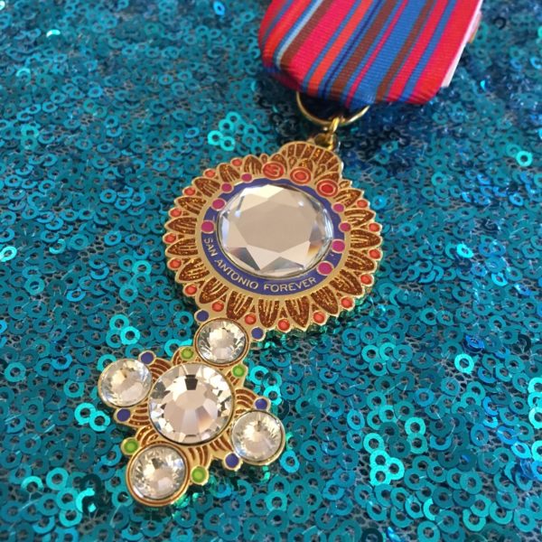 A close up of a medal on a blue sequined surface