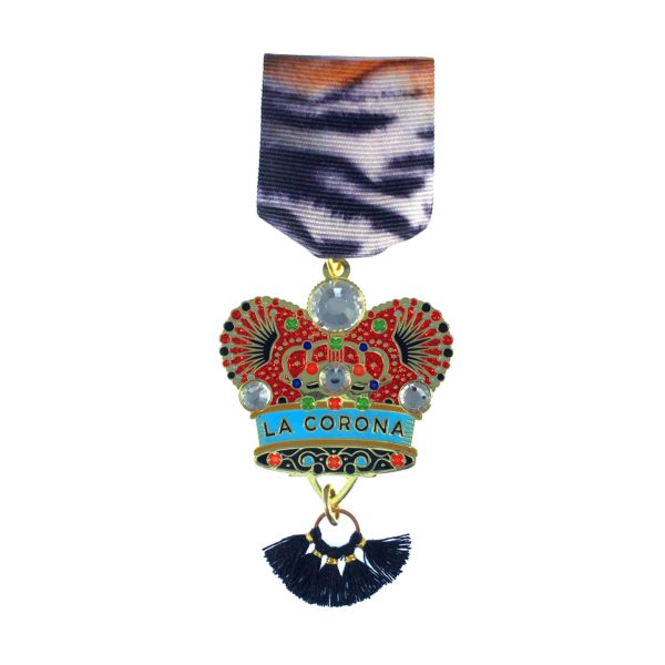 A medal with a crown and tassels on it.