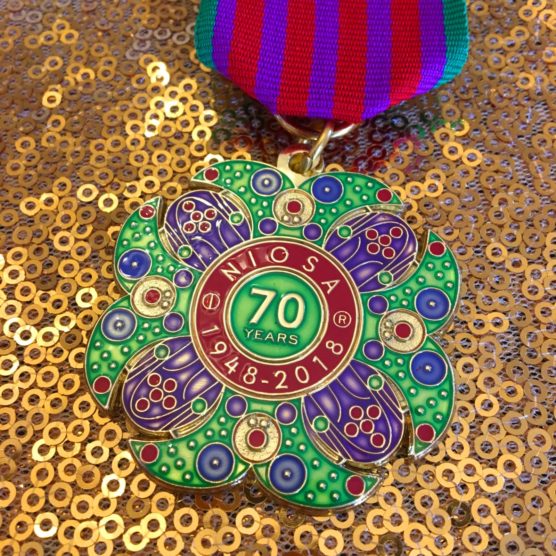 A colorful medal sitting on top of a table.