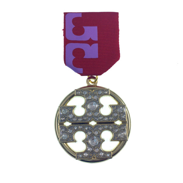 A medal with a purple ribbon and a silver circle.