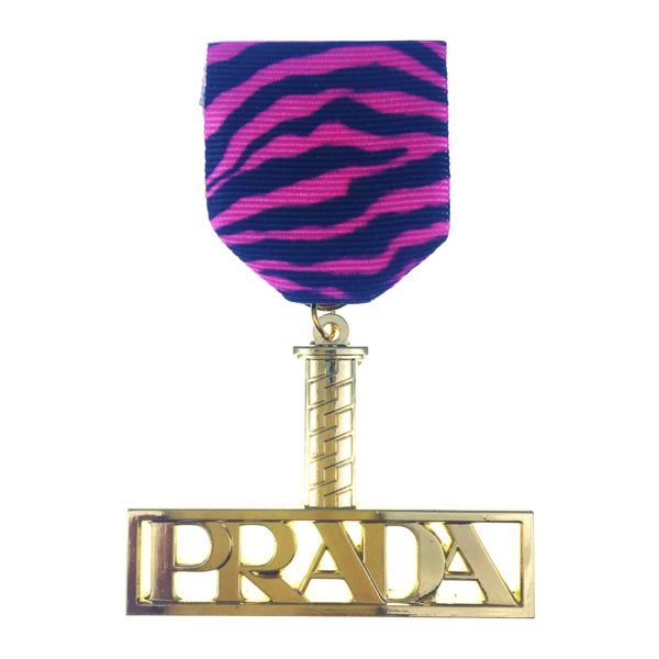 A pink and black zebra print ribbon with the word " prada ".